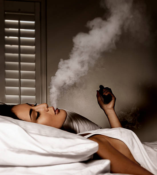istock Beautiful women smoking an electronic cigarette 578277284