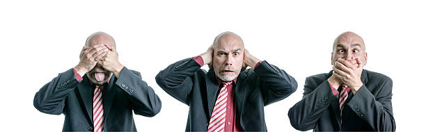 See no Evil Hear No Evil Speak No Evil A business man doing the "See no Evil Hear No Evil Speak No Evil" of the three wise monkeys and grimacing while doing it. speak no evil stock pictures, royalty-free photos & images