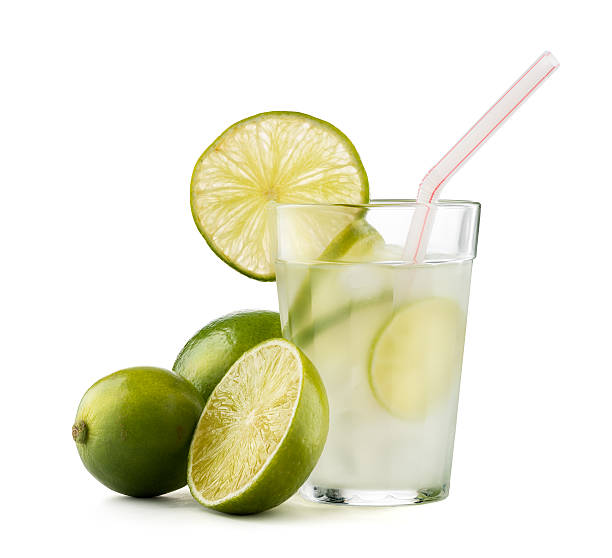 caipirinha cocktail with lime wedge isolated on white background - caipiroska imagens e fotografias de stock