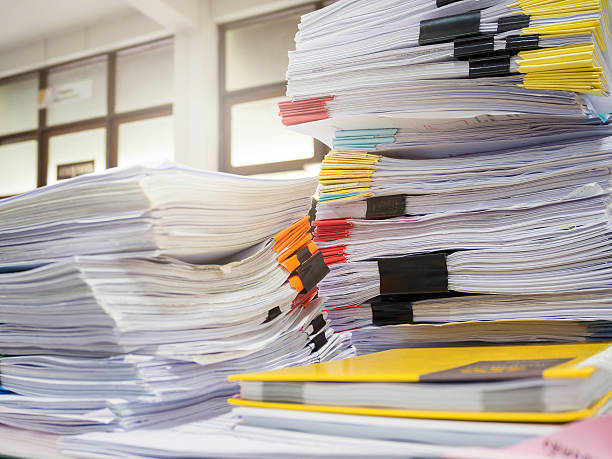 istock Pile of unfinished documents on office desk 578281262
