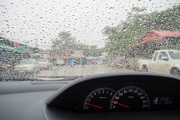 istock Drive in a rainy day, Rain drops on windshield car 578281650