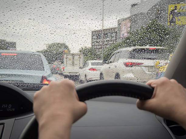 istock Drive in a rainy day, Rain drops on windshield car 578281682