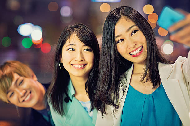 istock Three young and happy Japanese are taking selfie 578281884