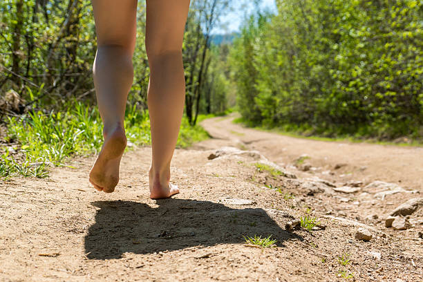 istock woman goes barefoot on the road 578282156