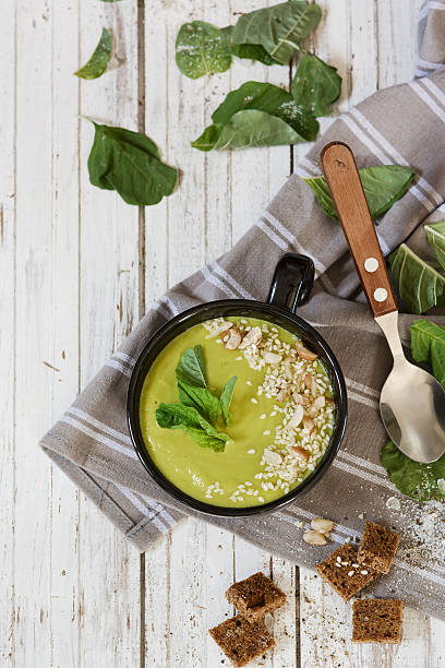 istock Avocado cream soup with nuts, spinach, croutons and sesame. 578283664