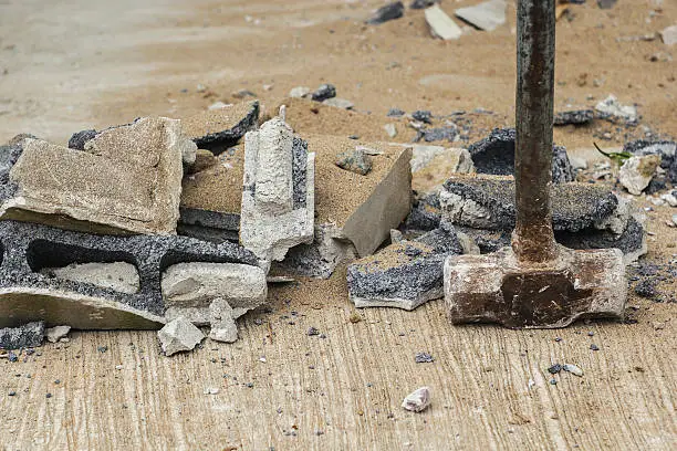 Photo of rust hammer on broken brick and cement