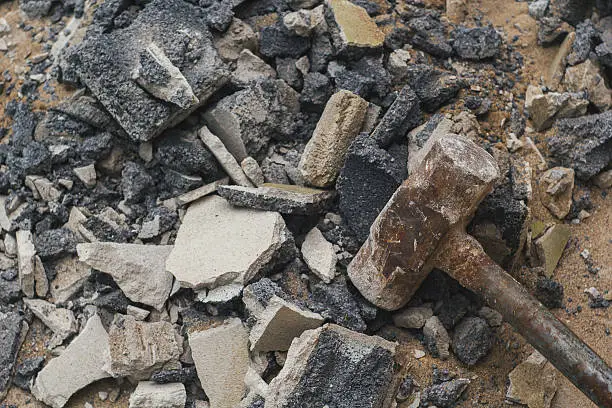 Photo of rust hammer on broken brick and cement