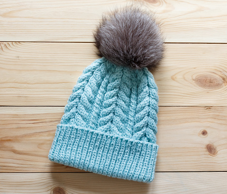 Fashionable handmade knitted hat with natural fluffy fur pompom