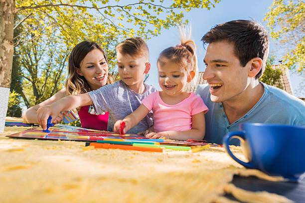 istock Cheerful family playing board game and having fun in backyard. 578287652