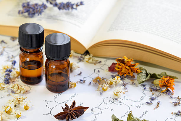 natural apothecary with essential oils and book stock photo