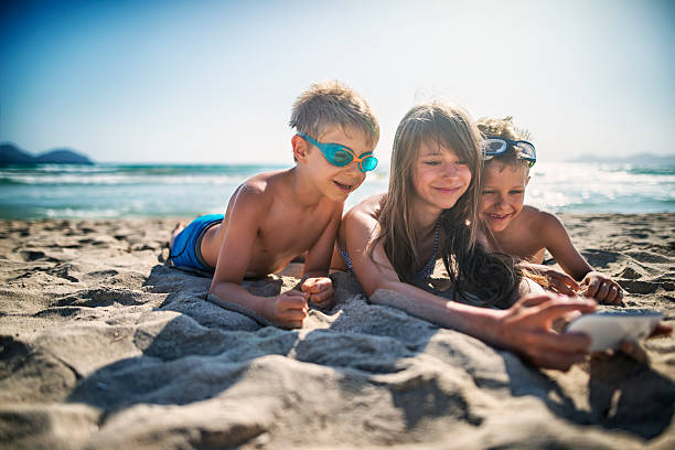 istock Kids taking selfie on the beach 578288894