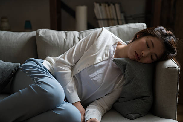 ama de casa cansada durmiendo en el sofá - trabajo pesado fotografías e imágenes de stock