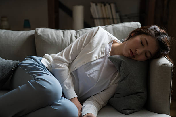 tired housewife sleeping on the sofa tired housewife sleeping on the sofa drudgery photos stock pictures, royalty-free photos & images