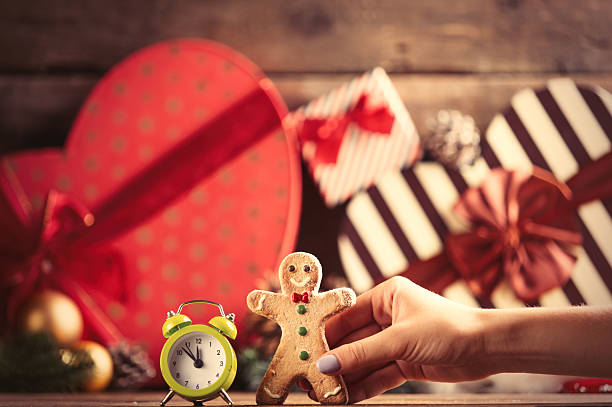 istock female hand holding gingerbread man 578290434