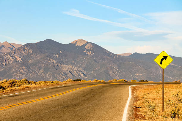 istock Sign warns of a right curve ahead on a road 578291490