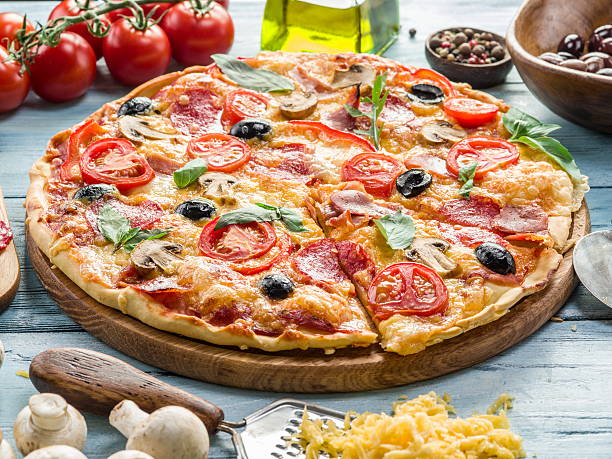istock Pizza with mushrooms, salami and tomatoes. 578291784