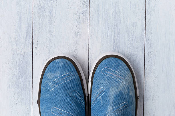 istock Blue canvas walking shoes on wood floor 578293674