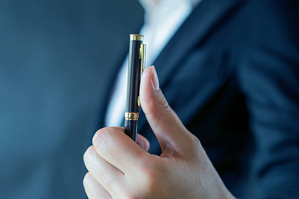 istock Girl hand holding pen 578293950