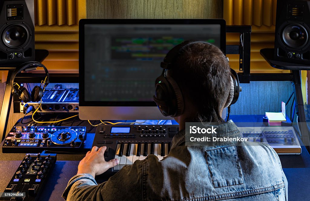 Man produce electronic music in studio Man produce electronic music in project home studio. Music Stock Photo