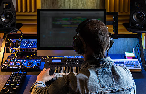 Man produce electronic music in studio Man produce electronic music in project home studio. composer stock pictures, royalty-free photos & images