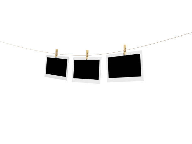 Three Polaroid Pictures Hanging On A Clothesline With Pins Stock