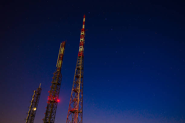 repeater radio antenna on mountain top and sky with stars