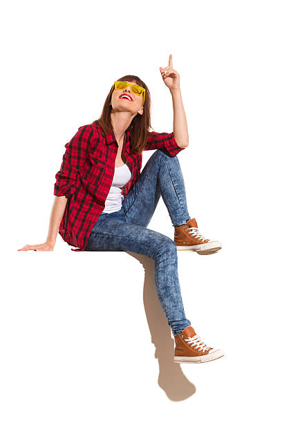 istock Sitting Girl Pointing Up 578296076
