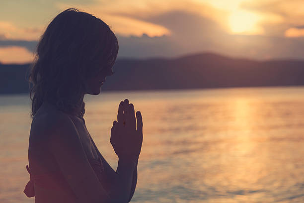 istock Young woman practicing yoga on the beach. 578296746