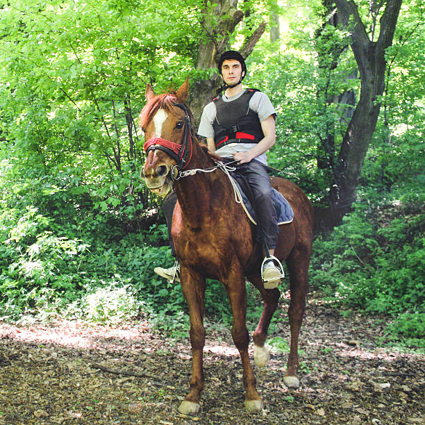 istock Young man riding a horse 578297650