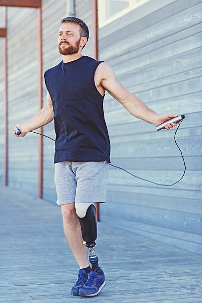 istock Handsome amputee male working out at summer beach location 578299308