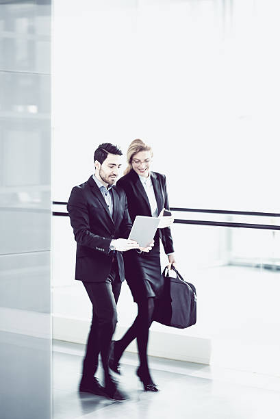 istock Two Business coworkers walking along office coridor 578299496