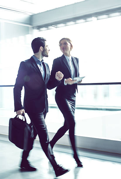 istock Two Business coworkers walking along office coridor 578299526