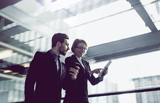 istock Two Business coworkers walking along office coridor 578300030