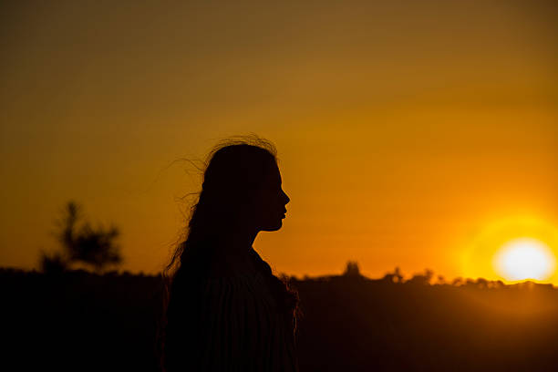 istock young girl watching the sunset 578300782