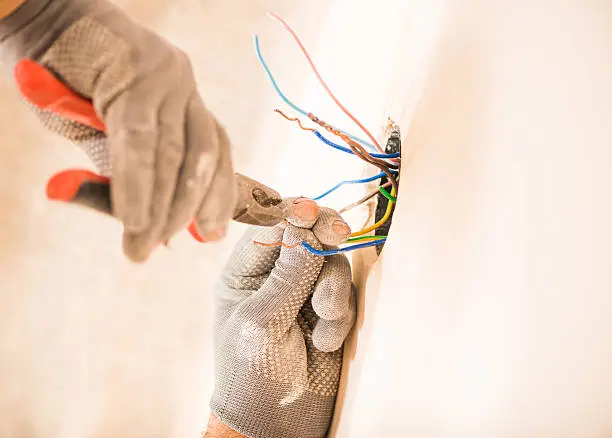 Photo of worker instaling electrical wires