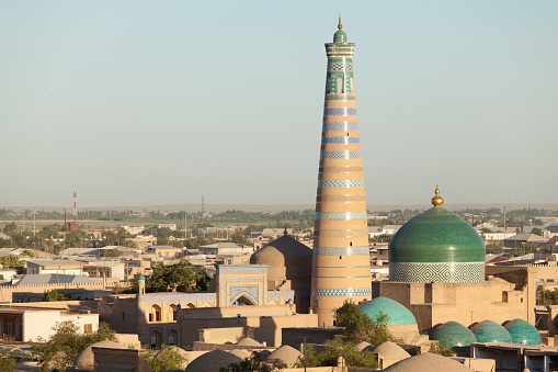 Evening view of Islom Hoja Minaret and Madrasa in Itchan Kala  - old centre of Khiva, Khorezm, Republic of Karakalpakstan, Uzbekistan.