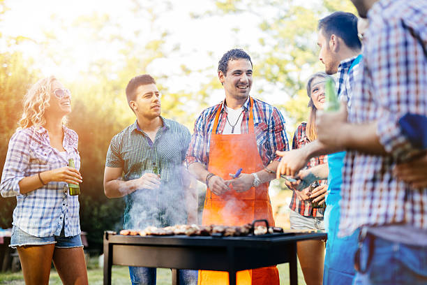 istock Young people grilling outdoors 578305852