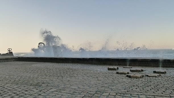 San Sebastian, Spain - April 7, 2011: The Comb of the Wind monument being splashed by a wave. Created by the sculptor Eduardo Chillida (San Sebastián, 1924-2002) and the architect  Luis Peña Ganchegui (Oñati, 1926-San Sebastián 2009), the Peine del Viento (Wind Comb) is the perfect example of beauty in its purest state, a profound dialogue between art and the landscape.