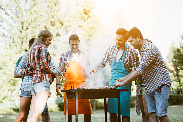 istock Young people grilling outdoors 578306040