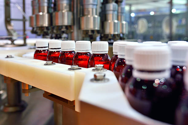 Oral Solution Production Line Close-up of the oral solution pharmaceutical in production line. pharmaceutical factory photos stock pictures, royalty-free photos & images
