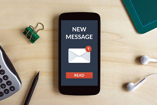 istock New message concept on smart phone screen on wooden desk 578307972