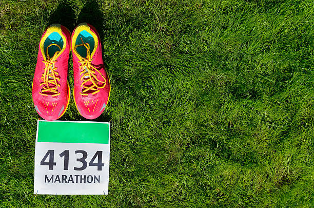 istock Running shoes and marathon race bib (number) on grass 578308292