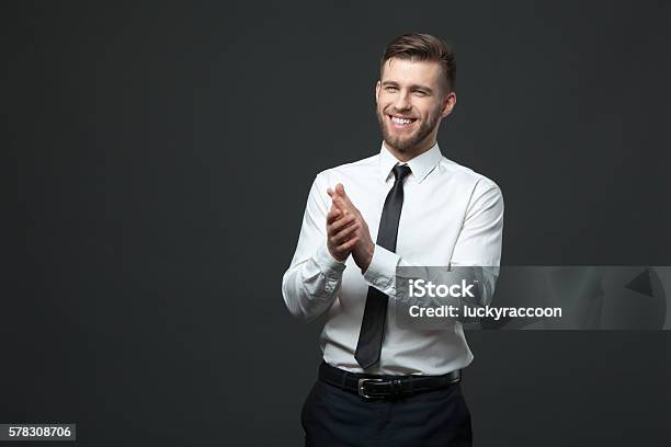 Studio Portrait Of Young Happy Handsome Businessman Claping Hands Stock Photo - Download Image Now