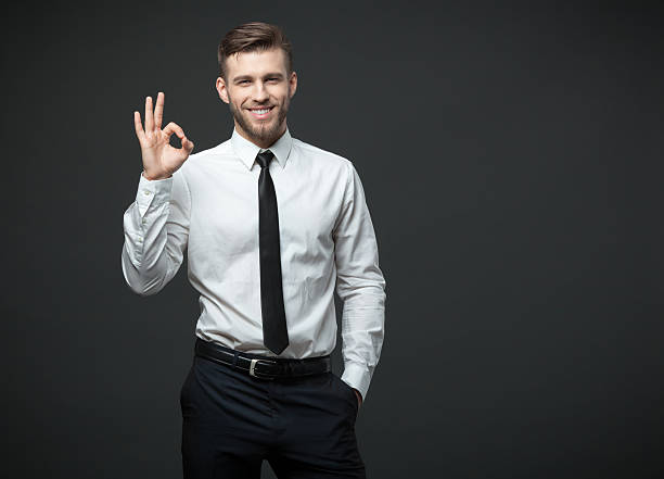 istock Handsome businessman showing okay sign on gray background. 578308972