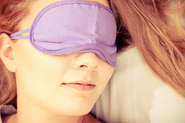 istock Sleeping woman wearing blindfold sleep mask. 578310220