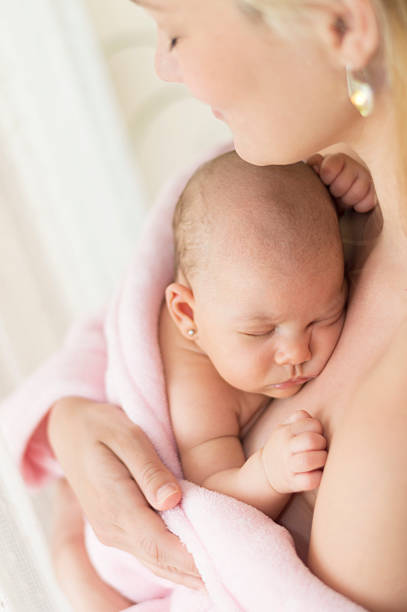 istock Newborn baby in mother's arms 578311302