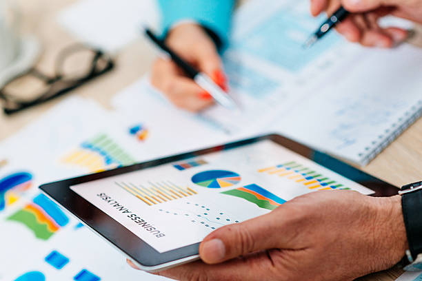 istock Professionals dealing with stock market data 578311960