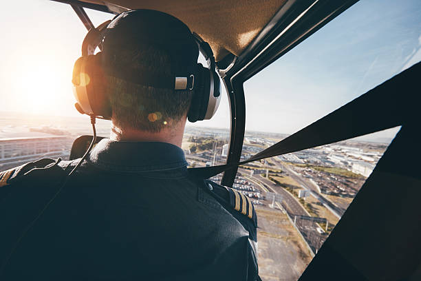 istock Pilot flying a helicopter over a city 578312028