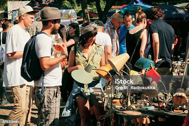 Flea Market With Young People Choosing Vintage Furniture Stock Photo - Download Image Now