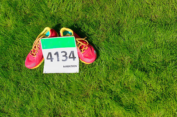 istock Running shoes and marathon race bib (number) on grass 578554974